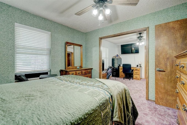 bedroom featuring carpet flooring, ceiling fan, and a textured ceiling