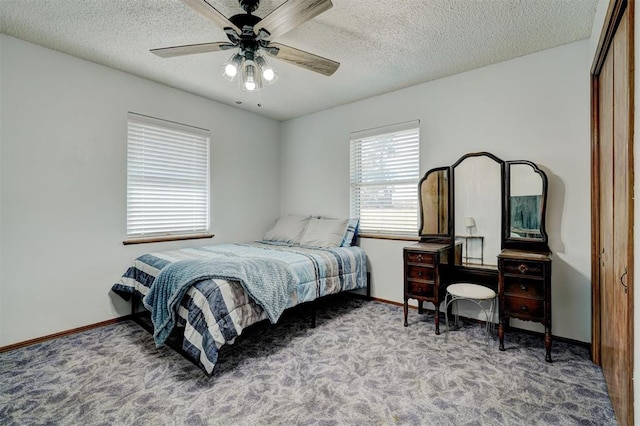 carpeted bedroom featuring ceiling fan, a closet, and a textured ceiling