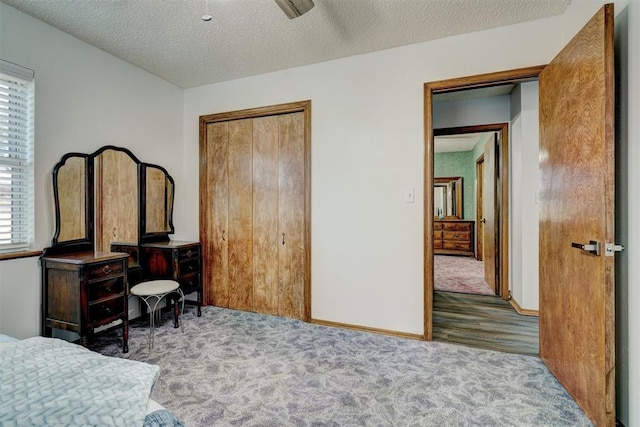 bedroom with hardwood / wood-style floors, a textured ceiling, multiple windows, and ceiling fan