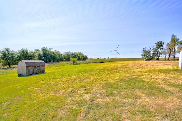 view of yard featuring a rural view and a storage unit