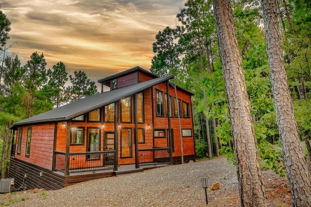 property exterior at dusk featuring central AC unit