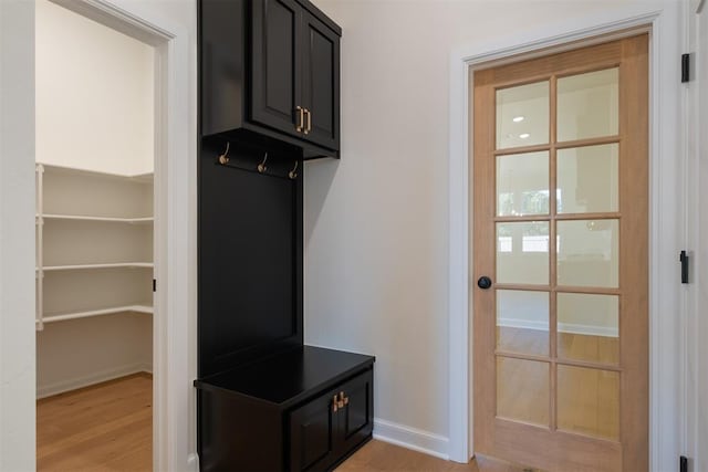 mudroom with light hardwood / wood-style floors