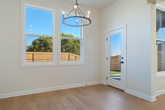 interior space with light hardwood / wood-style floors and a chandelier