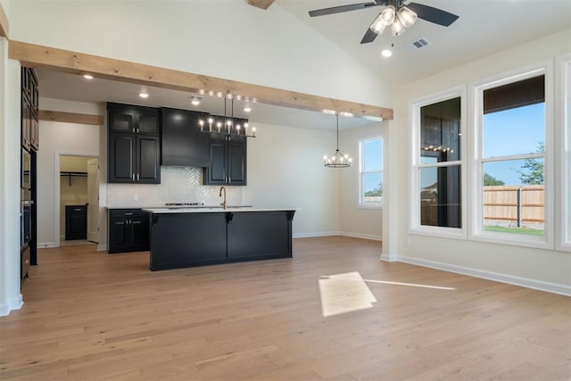 kitchen featuring a kitchen island with sink, pendant lighting, a healthy amount of sunlight, and light hardwood / wood-style floors