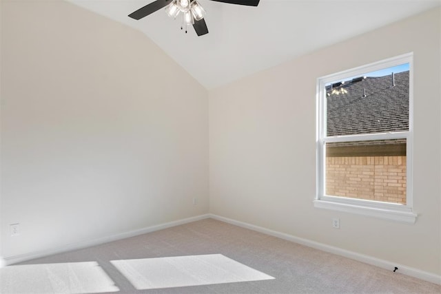 unfurnished room featuring plenty of natural light, ceiling fan, light colored carpet, and vaulted ceiling