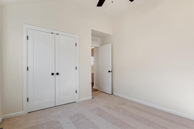 1103 Mount Irving Way, Norman, OK 73071 - unfurnished bedroom featuring light colored carpet, baseboards, a closet, and a ceiling fan
