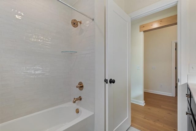 bathroom featuring vanity, tiled shower / bath, and hardwood / wood-style flooring