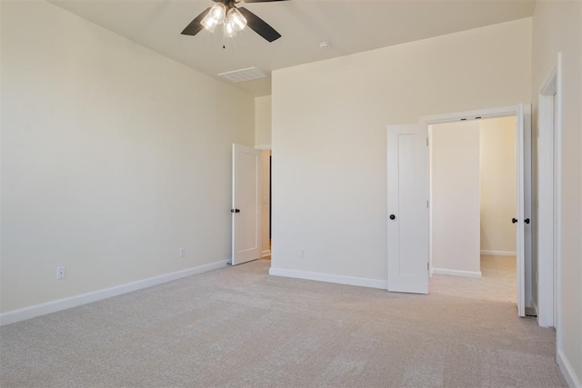 unfurnished bedroom with ceiling fan and light colored carpet