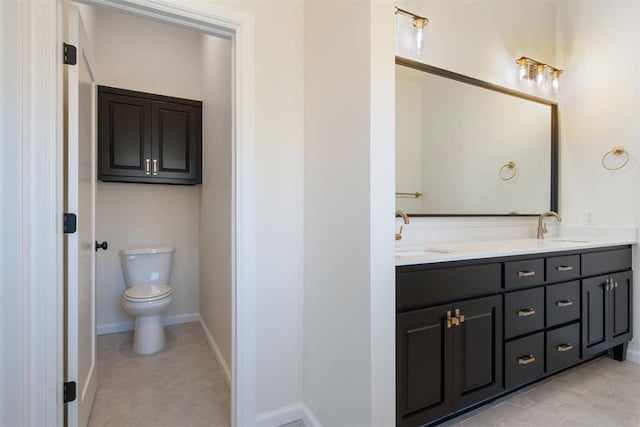 1103 Mount Irving Way, Norman, OK 73071 - bathroom featuring double vanity, toilet, tile patterned floors, and baseboards