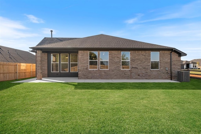 back of house with central air condition unit, a yard, and a patio