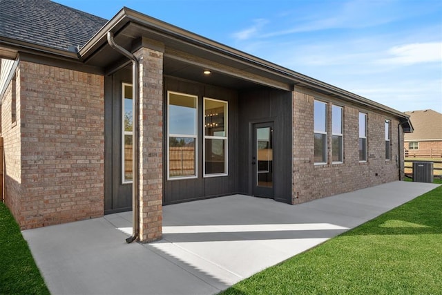 1103 Mount Irving Way, Norman, OK 73071 - rear view of house featuring a patio, brick siding, central AC, and a yard