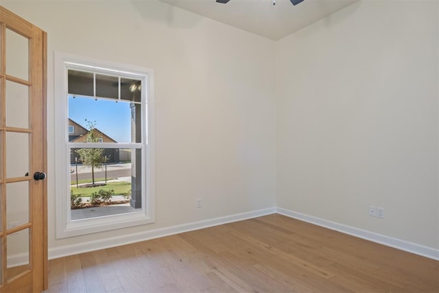 spare room with ceiling fan and wood-type flooring