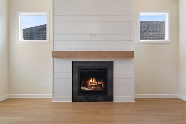 1103 Mount Irving Way, Norman, OK 73071 - detailed view of baseboards, wood finished floors, and a tiled fireplace