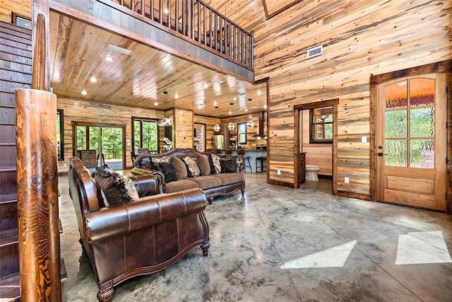 living room with wooden ceiling and a high ceiling