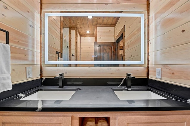 bathroom with wood walls and vanity