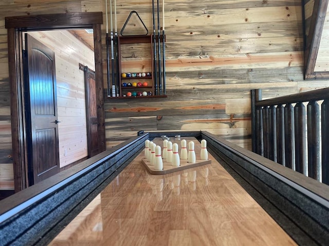 bar featuring hardwood / wood-style floors and wood walls