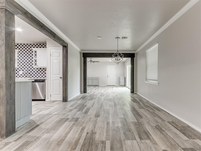 unfurnished dining area featuring ceiling fan, light wood-type flooring, and ornamental molding