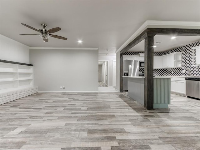 unfurnished living room featuring ceiling fan, light hardwood / wood-style floors, and crown molding