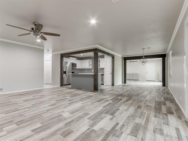 unfurnished living room featuring light hardwood / wood-style flooring, ceiling fan, and crown molding