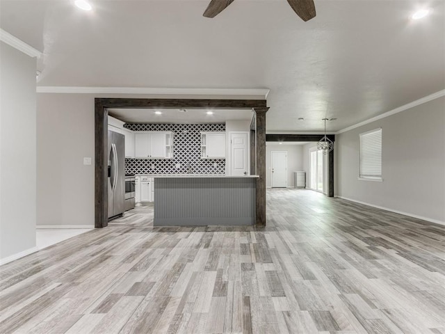 unfurnished living room with crown molding, ceiling fan, and light wood-type flooring