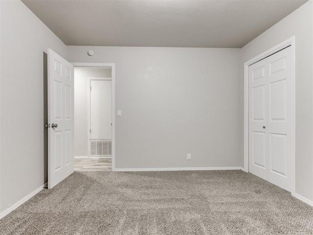 unfurnished bedroom featuring a closet and carpet