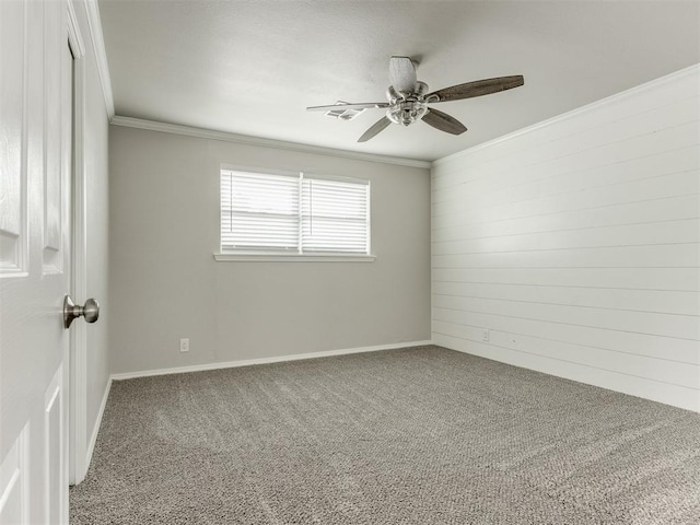 spare room featuring ceiling fan, carpet floors, and crown molding