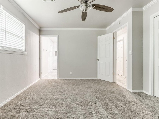 spare room with light carpet, crown molding, and ceiling fan