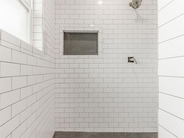 bathroom with a tile shower