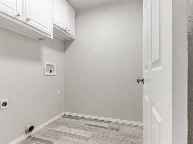 laundry area with cabinets, hookup for a washing machine, light wood-type flooring, and hookup for an electric dryer