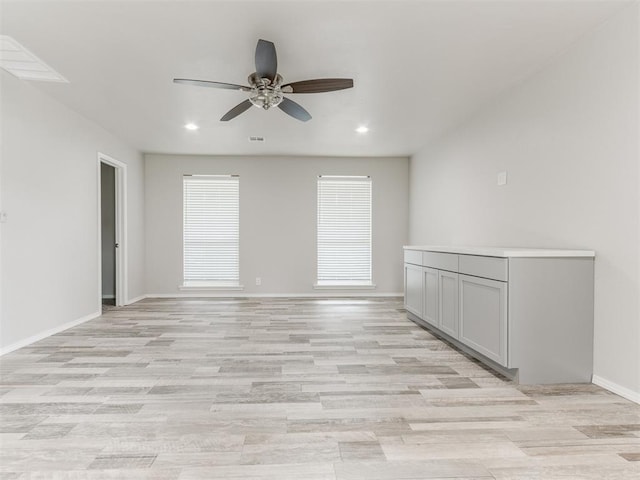 unfurnished room with light hardwood / wood-style flooring and ceiling fan