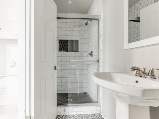 bathroom with sink and an enclosed shower