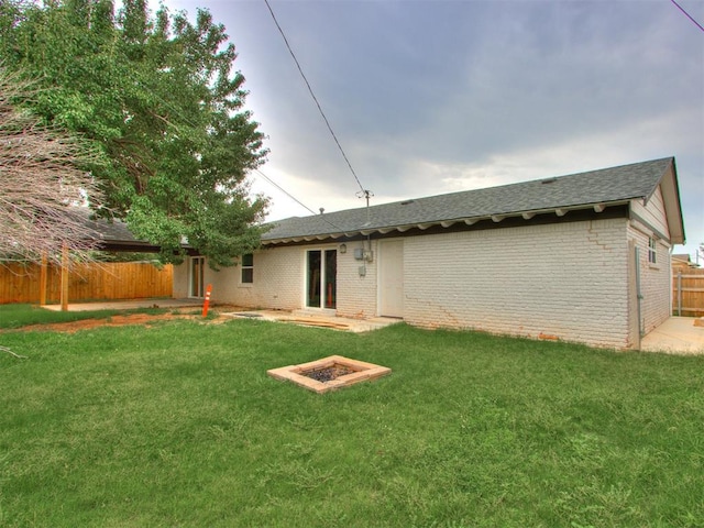 rear view of property with a lawn