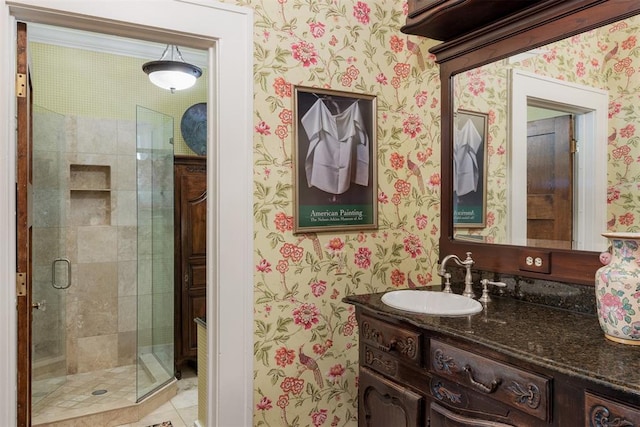 bathroom with tile patterned flooring, vanity, and a shower with door