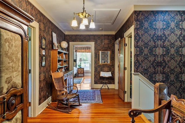 living area with light hardwood / wood-style floors and a notable chandelier