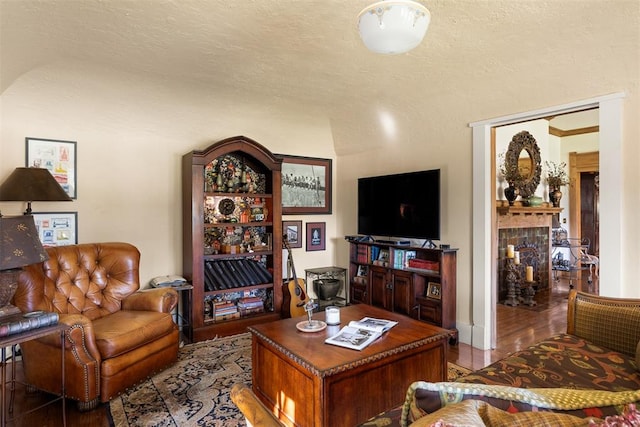 living room with hardwood / wood-style floors and a textured ceiling