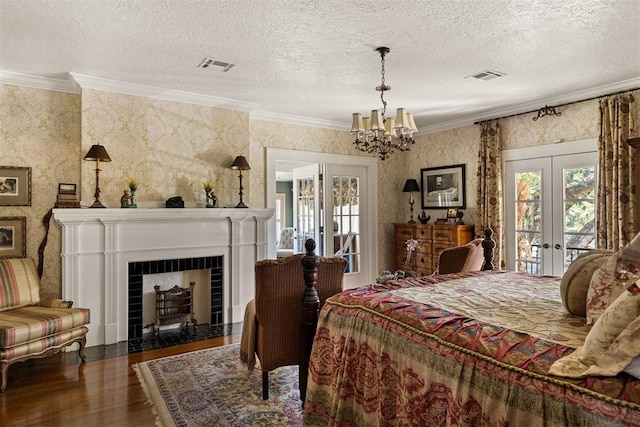 bedroom featuring dark hardwood / wood-style floors, crown molding, access to outside, and french doors