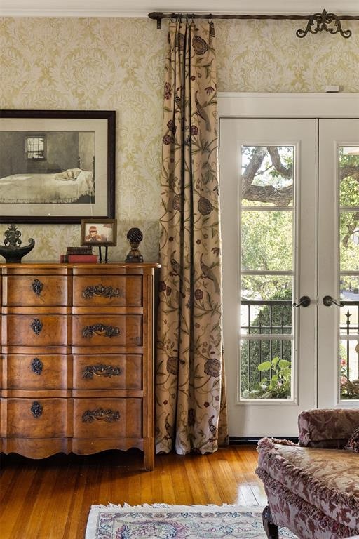 entryway featuring french doors, plenty of natural light, and hardwood / wood-style flooring