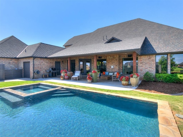 view of pool featuring outdoor lounge area, an in ground hot tub, a patio, and grilling area