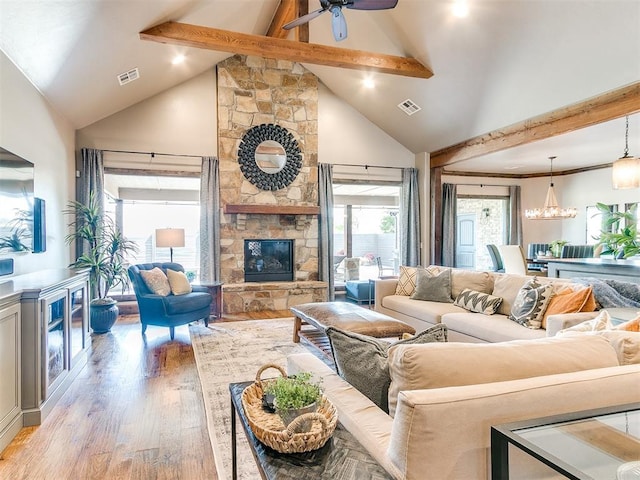 1205 Cobblestone Ln, Kingfisher, OK 73750 - living area featuring beamed ceiling, light wood-style floors, a fireplace, a ceiling fan, and high vaulted ceiling