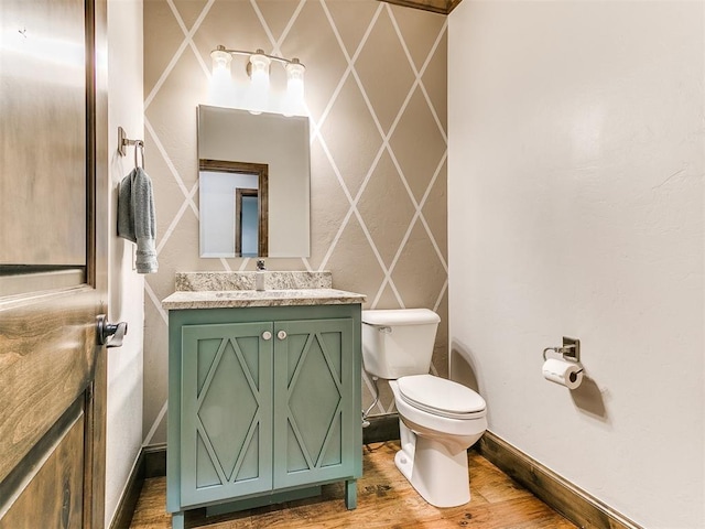 bathroom featuring hardwood / wood-style floors, vanity, and toilet