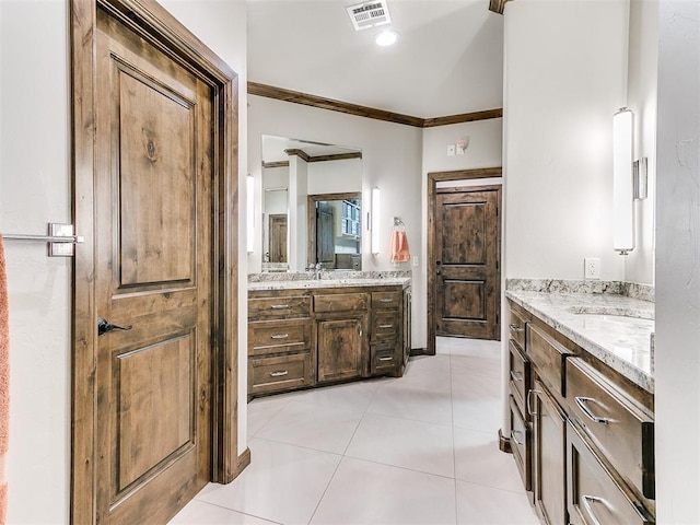 bathroom with tile patterned flooring, vanity, and crown molding