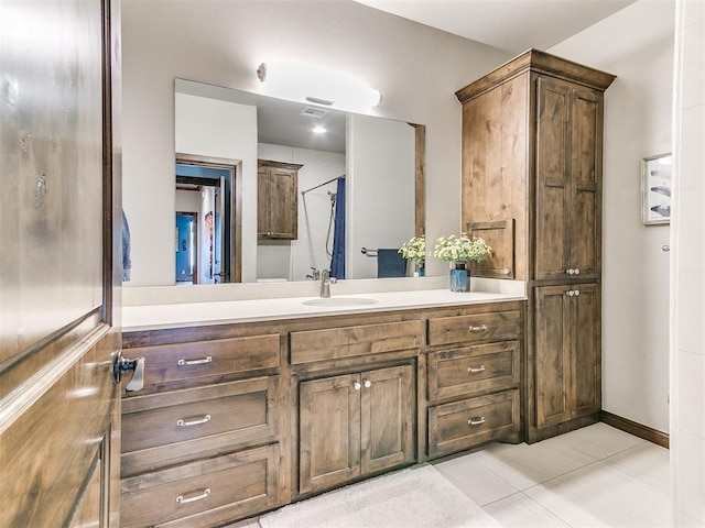 bathroom featuring tile patterned flooring and vanity