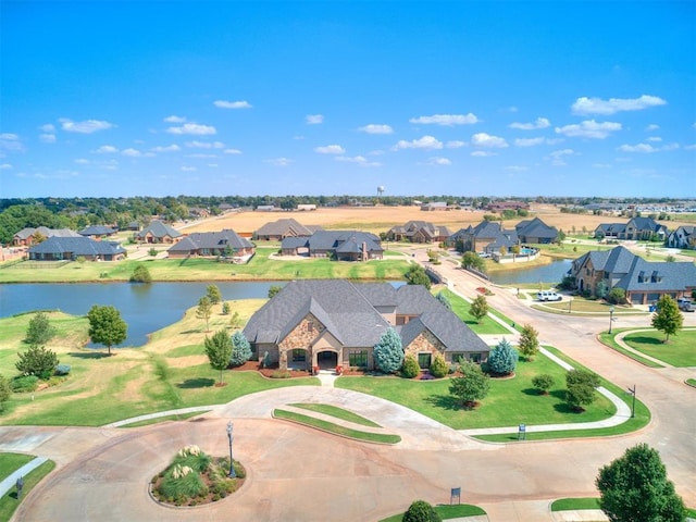 drone / aerial view with a water view and a residential view
