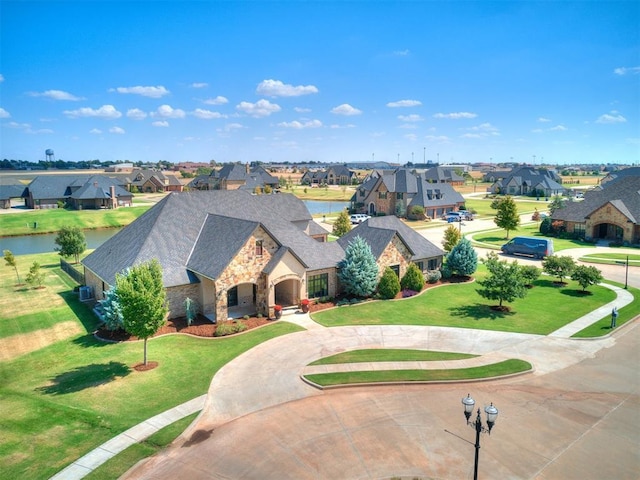 birds eye view of property with a water view and a residential view