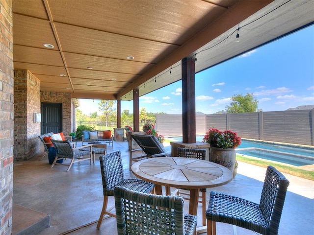 view of patio with fence private yard, an outdoor hangout area, and a fenced in pool