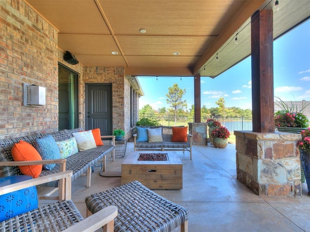 view of patio featuring fence and an outdoor living space with a fire pit