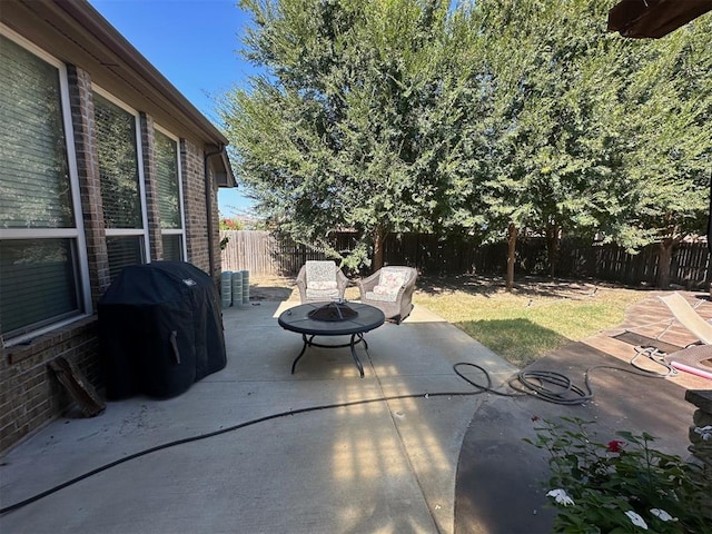 view of patio / terrace featuring a grill and an outdoor fire pit