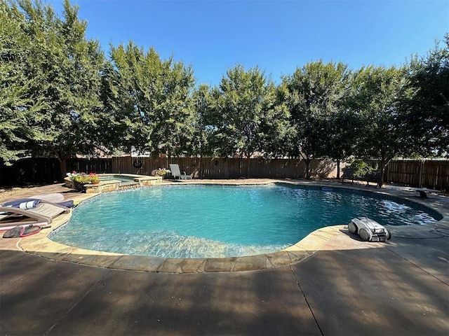 view of swimming pool with an in ground hot tub and a patio