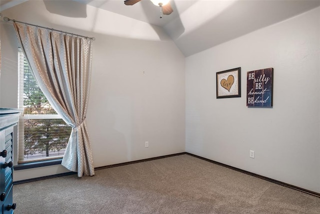 carpeted empty room with vaulted ceiling and ceiling fan