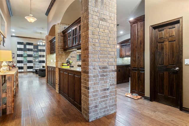 hallway featuring light hardwood / wood-style floors and crown molding